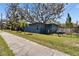Charming one story home with mature landscaping, sidewalk, and a fenced yard at 725 Philippe Pkwy, Safety Harbor, FL 34695