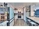 Modern kitchen with white cabinets, blue appliances, stylish finishes, and breakfast bar seating at 725 Philippe Pkwy, Safety Harbor, FL 34695