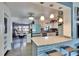 Stylish kitchen with white cabinets, granite countertops, stainless steel appliances, and open to the living area at 725 Philippe Pkwy, Safety Harbor, FL 34695