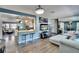 Inviting living space with blue accent wall, modern decor, and open layout connecting to the kitchen at 725 Philippe Pkwy, Safety Harbor, FL 34695