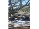 Outdoor seating area featuring a fire pit, comfortable chairs, and a blue and white rug under a large tree at 725 Philippe Pkwy, Safety Harbor, FL 34695