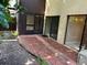 Outdoor patio with brick flooring and sliding glass doors, perfect for outdoor living at 730 S Village N Dr # 101, St Petersburg, FL 33716