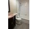 Bright bathroom featuring tile floors, tub, shower, and vanity with granite countertop at 730 S Village N Dr # 101, St Petersburg, FL 33716