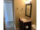 Bathroom showcasing a vanity, marble countertop, modern fixtures, and ample storage space at 730 S Village N Dr # 101, St Petersburg, FL 33716