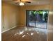 Cozy bedroom with sliding glass doors, plush carpeting, and ample natural light at 730 S Village N Dr # 101, St Petersburg, FL 33716