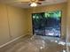 Bright bedroom featuring sliding doors, ceiling fan and access to a private patio at 730 S Village N Dr # 101, St Petersburg, FL 33716