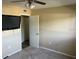 Bedroom featuring a ceiling fan, television, closet, and carpeted floors at 730 S Village N Dr # 101, St Petersburg, FL 33716