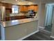 Updated kitchen features stainless steel appliances, granite counters, and wood cabinets at 730 S Village N Dr # 101, St Petersburg, FL 33716