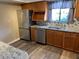 Bright kitchen featuring stainless steel appliances, wood cabinets, and modern backsplash at 730 S Village N Dr # 101, St Petersburg, FL 33716