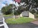 Community sign for Village Lake Condominiums with a manicured lawn at 730 S Village N Dr # 101, St Petersburg, FL 33716