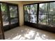 Enclosed sunroom with screened windows and tiled floor, offering ample natural light at 730 S Village N Dr # 101, St Petersburg, FL 33716