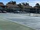 Community tennis court with fencing and parking lot and buildings in the background at 730 S Village N Dr # 101, St Petersburg, FL 33716