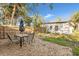 Backyard with a patio table, fenced yard, and plenty of space for outdoor activities at 7301 S Swoope St, Tampa, FL 33616