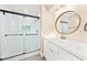 This bathroom showcases a vanity, decorative mirror, and tiled glass shower at 7301 S Swoope St, Tampa, FL 33616