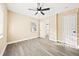 Bright bedroom features neutral walls, a ceiling fan, window, and light wood-look floors at 7301 S Swoope St, Tampa, FL 33616