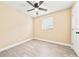 The bedroom features neutral walls, light wood-look floors, and a window for natural light at 7301 S Swoope St, Tampa, FL 33616