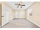 Spacious bedroom with light wood flooring, ceiling fan, and bright natural light from windows at 7301 S Swoope St, Tampa, FL 33616
