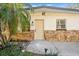 Close-up of a home's entrance, highlighting the stone details, front door, and address number at 7301 S Swoope St, Tampa, FL 33616