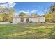 Exterior rear view of a home with fresh green grass at 7301 S Swoope St, Tampa, FL 33616