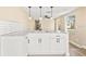 Bright kitchen with white cabinets, granite countertops, subway tile backsplash, and modern pendant lighting at 7301 S Swoope St, Tampa, FL 33616