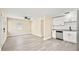 Bright, open-plan living space with modern white cabinetry and stainless steel appliances at 7301 S Swoope St, Tampa, FL 33616