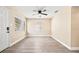 Living room with natural light, ceiling fan, and updated flooring for a welcoming atmosphere at 7301 S Swoope St, Tampa, FL 33616