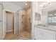 Bathroom featuring a glass-enclosed shower, vanity with granite countertop, and tiled floors at 7326 Blue Beech Dr, Riverview, FL 33578