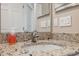 Bathroom vanity featuring granite countertops, a sink, brushed nickel faucet, and dual mirrors at 7326 Blue Beech Dr, Riverview, FL 33578