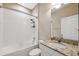 Cozy bathroom featuring a tub with white tile surround and granite countertop vanity at 7326 Blue Beech Dr, Riverview, FL 33578