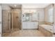 Bathroom featuring walk-in shower, bathtub, and double vanity at 7326 Blue Beech Dr, Riverview, FL 33578