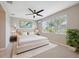 Bedroom featuring a large window, ceiling fan, and neutral decor at 7326 Blue Beech Dr, Riverview, FL 33578