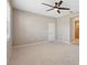 Bedroom with neutral carpet, ceiling fan, and access to an ensuite bathroom at 7326 Blue Beech Dr, Riverview, FL 33578