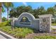 A stone community sign for Summerwood with lush landscaping and mature trees around the entrance at 7326 Blue Beech Dr, Riverview, FL 33578