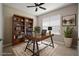 Comfortable home office featuring a sleek desk, a wall bookshelf, and a light-filled window at 7326 Blue Beech Dr, Riverview, FL 33578