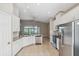 Bright kitchen features granite countertops, stainless steel appliances, and tile flooring at 7326 Blue Beech Dr, Riverview, FL 33578