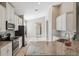 Modern kitchen featuring white cabinets, granite counters, tile backsplash and stainless appliances at 7326 Blue Beech Dr, Riverview, FL 33578