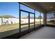 Enclosed lanai with a view of the backyard and privacy fence at 7326 Blue Beech Dr, Riverview, FL 33578
