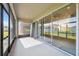 Enclosed lanai with screened windows and sliding glass doors leading to the backyard at 7326 Blue Beech Dr, Riverview, FL 33578