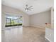 Living room featuring tile flooring, sliding glass doors, and a ceiling fan at 7326 Blue Beech Dr, Riverview, FL 33578