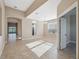 Open-concept living area with tile flooring, archways, and access to other rooms, perfect for entertaining at 7326 Blue Beech Dr, Riverview, FL 33578