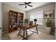 Home office featuring a ceiling fan, a window providing natural light, and built-in bookshelf at 7326 Blue Beech Dr, Riverview, FL 33578