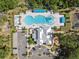 Aerial view of the community pool, water slide, bath house, playground and parking at 7326 Blue Beech Dr, Riverview, FL 33578