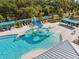 The zero entry community pool features a fun water slide for all ages at 7326 Blue Beech Dr, Riverview, FL 33578