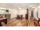 Dining room with wood flooring, table and chairs, and view into kitchen with breakfast bar at 8100 Roxboro Dr, Hudson, FL 34667