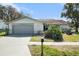 Charming single-story home featuring a two-car garage and well-maintained front lawn at 8100 Roxboro Dr, Hudson, FL 34667