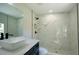 Close-up of modern bathroom with glass shower, sleek fixtures and white marble-tiled walls at 8119 E 19Th Ave, Tampa, FL 33619