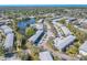 Aerial view of community featuring mature trees, pool, walking bridge and nearby waterways at 8325 112Th St # 202, Seminole, FL 33772
