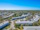 Wide aerial view of community featuring landscaping, pool, parking, and nearby waterways at 8325 112Th St # 202, Seminole, FL 33772