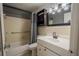 Bathroom with updated vanity, storage, and shower/tub combo at 8325 112Th St # 202, Seminole, FL 33772
