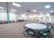 Large hall with tables, chairs, and carpet flooring at 8325 112Th St # 202, Seminole, FL 33772